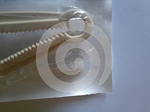 Yellow plastic umbilical cord clamp used to clamp off the umbilical cord after a baby\'s birth