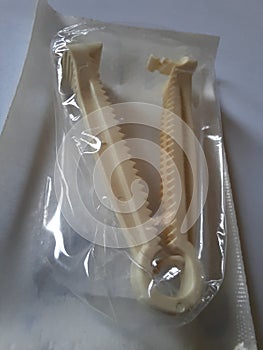 Yellow plastic umbilical cord clamp used to clamp off the umbilical cord after a baby\'s birth