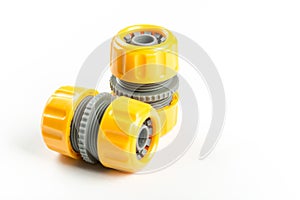 Yellow plastic water hose connectors isolated over white background