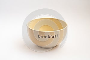 Yellow plate with breakfast inscription isotated on white background
