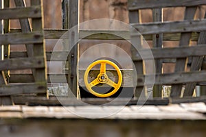 Yellow play steering wheel on a wooden tractor model