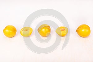 Yellow plum fruit on the white background