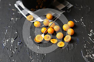 Yellow plums on the black background. Ingredients for a jam. Food photography. Autumn Concept,