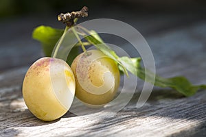 Yellow plums on a table