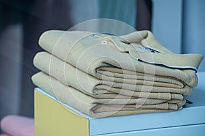 yellow polos stack in a men fashion store photo