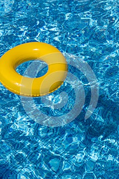 Yellow pool float, pool ring in cool blue refreshi photo