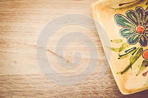 yellow porcelain tablemat on a pastel green wood surface