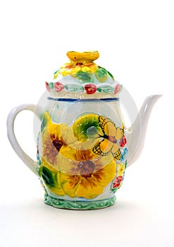 Yellow porcelain teapot with ornament flowers and butterfly.