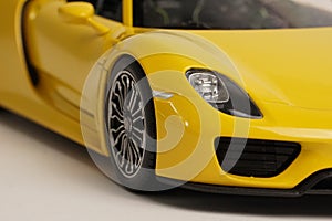 Yellow Porsche 918 Spyder model convertible car close up of front wheel