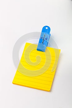 Yellow post note and blue clip