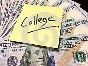 Yellow Post it note with handwritten word college on money photo