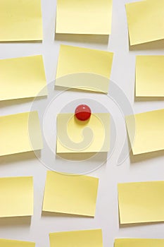 Yellow post it note and magnet button on whiteboard