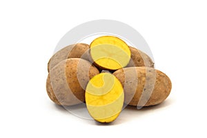 Yellow potatoes on white ground photo