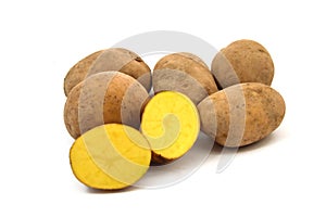 Yellow potatoes on white ground photo