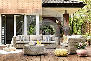 Yellow pouf on wooden patio