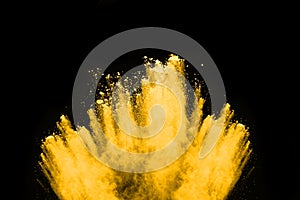 Yellow powder explosion on black background.