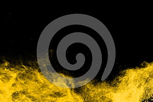 Yellow powder explosion on black background.