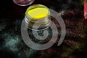 Yellow powder for nails on black background