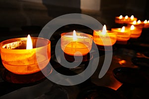 Yellow prayer candles in a church