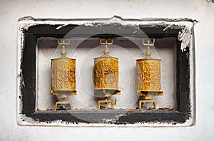 Yellow prayer wheels with mantras