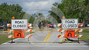 Yellow protective barrier at street construction site. Warning road sign about utility work