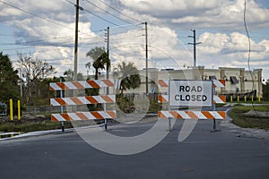 Yellow protective barrier at street construction site. Warning road sign about utility work