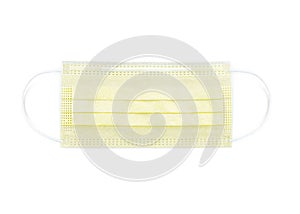 Yellow protective face mask. Disposable medical face mask isolated on white background closeup.