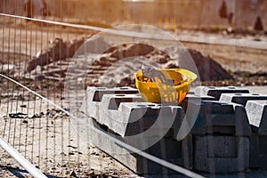 Yellow protective helmet on construction site