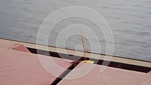 Yellow protective lead seal installed to safely lock cargo holds with wheat on bulker ship at sea grain terminal in