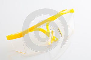 Yellow protective spectacles isolated on white background