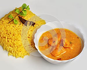 Yellow pulao and Prawn malai curry with coconut milk photo