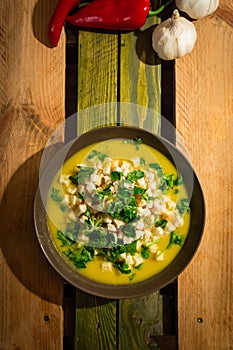 Yellow pumpkin soup with croutons and parsley