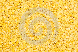 Yellow purified lentil closeup top view background.