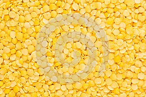 Yellow purified lentil closeup top view background.