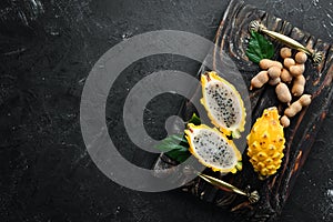 Yellow Pytahya on a black background. Fruit Dragon. Tropical Fruits. Top view.