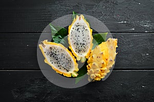 Yellow Pytahya on a black background. Fruit Dragon. Tropical Fruits. Top view.