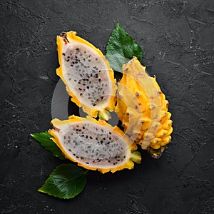Yellow Pytahya on a black background. Fruit Dragon. Tropical Fruits. Top view.