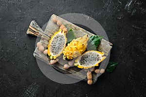 Yellow Pytahya on a black background. Fruit Dragon. Tropical Fruits. Top view.