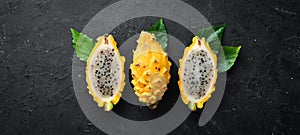 Yellow Pytahya on a black background. Fruit Dragon. Tropical Fruits. Top view.