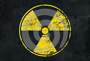 Yellow radioactive sign over black background