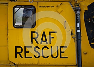 Yellow RAF Royal Air Force rescue military Sea King helicopter writing text on sliding metal aircraft door