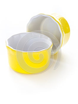 Yellow ramekins on white background.