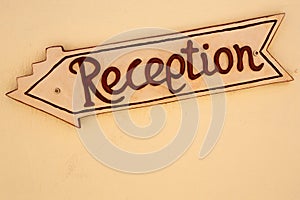 A yellow reception sign board in a hotel
