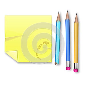 Yellow record sheet with three pencils on white background