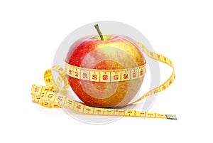 Yellow-red apple and measurement tape