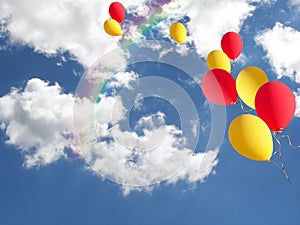 yellow and red balloons with rainbow