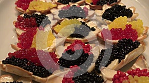 yellow, red and black fish caviar dish on the table of chrismast holiday