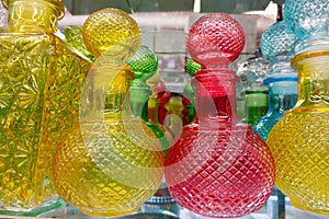 Yellow, red and blue decanters close-up.