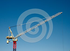 Yellow red and blue hoisting crane photo