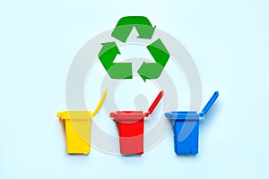 Yellow, red and blue recycle bins with recycle symbol. Recycling concept